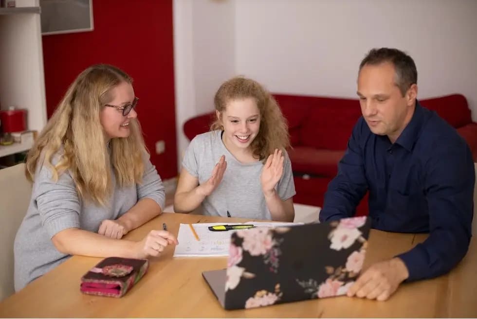 family of three viewing computer together